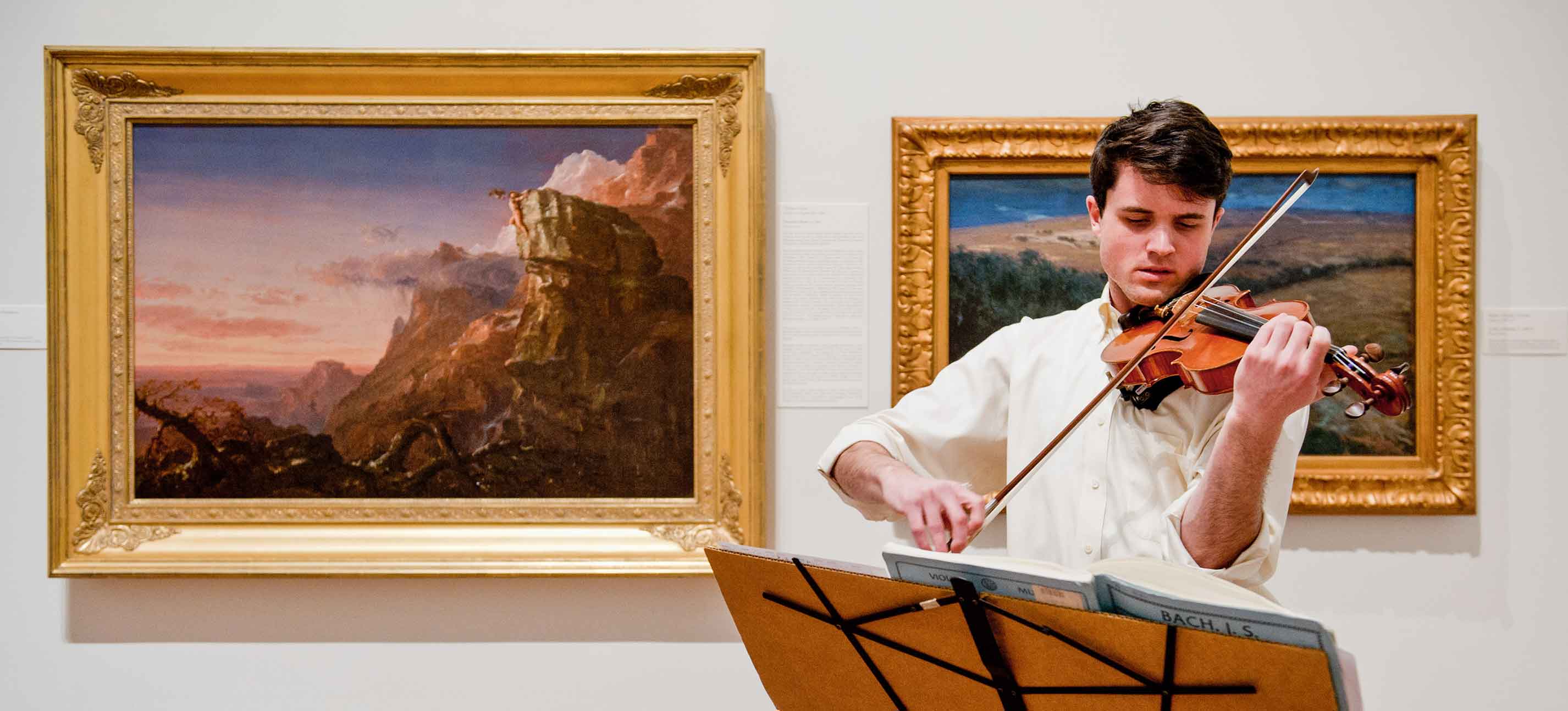 Person playing violin in the Frances Lehman Loeb Art Gallery