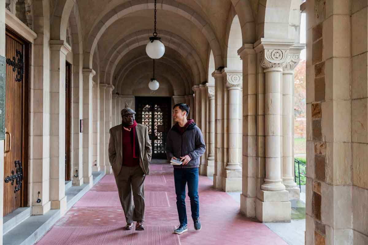 Professor and student walking on campus