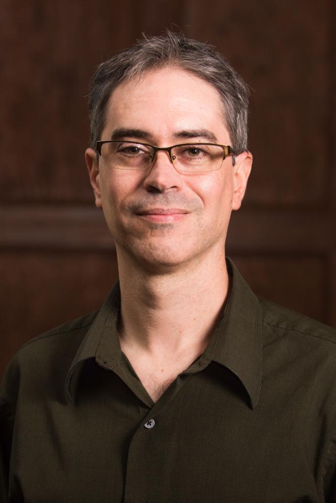 David J. Esteban wearing a dark shirt.