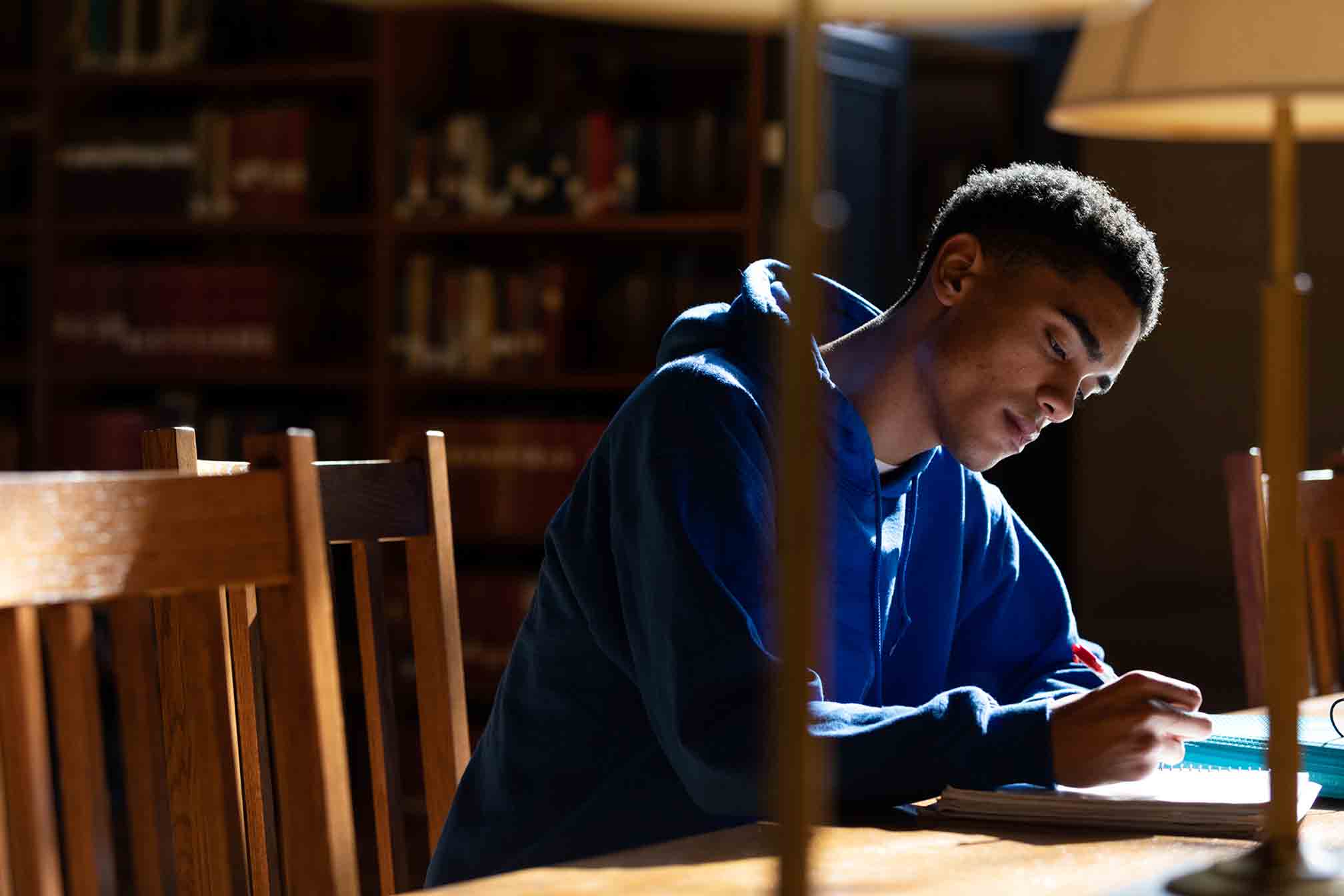 Student studying on the lawn in front of Main Building