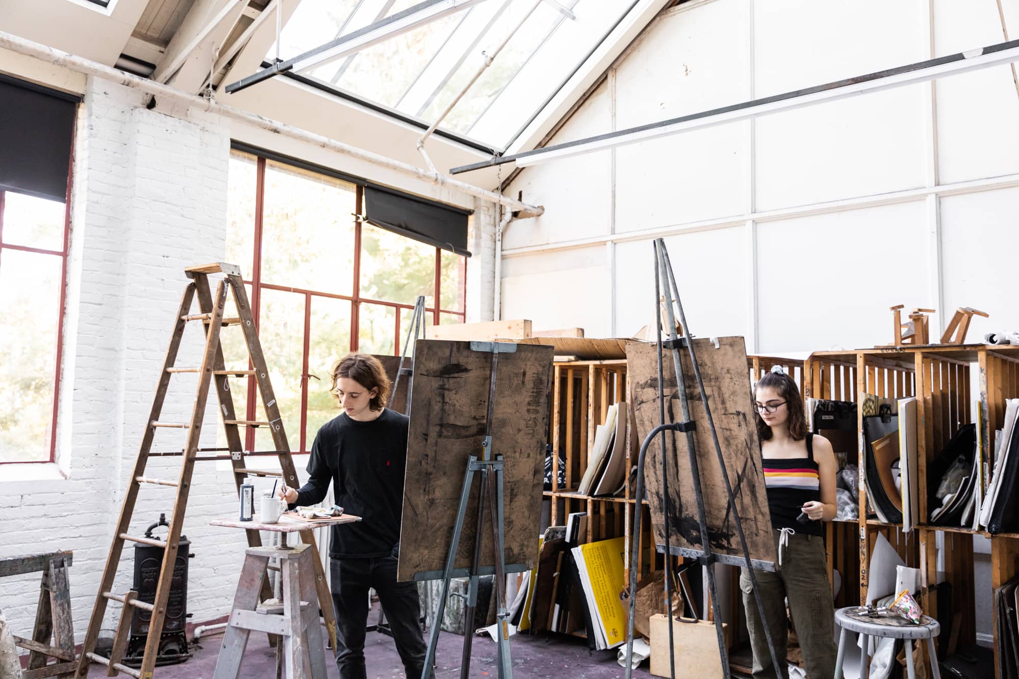 A person working on a painting in the art studio