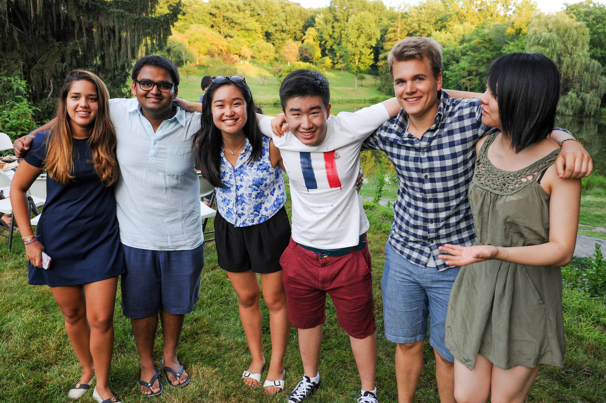 Five students standing arm in arm