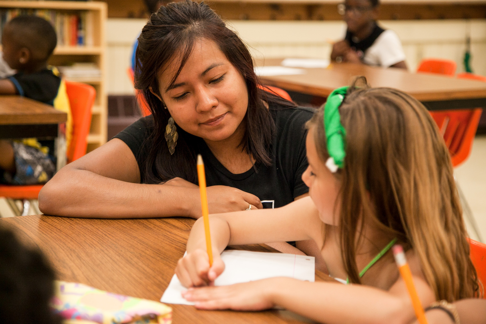 A student helping a child with their homework