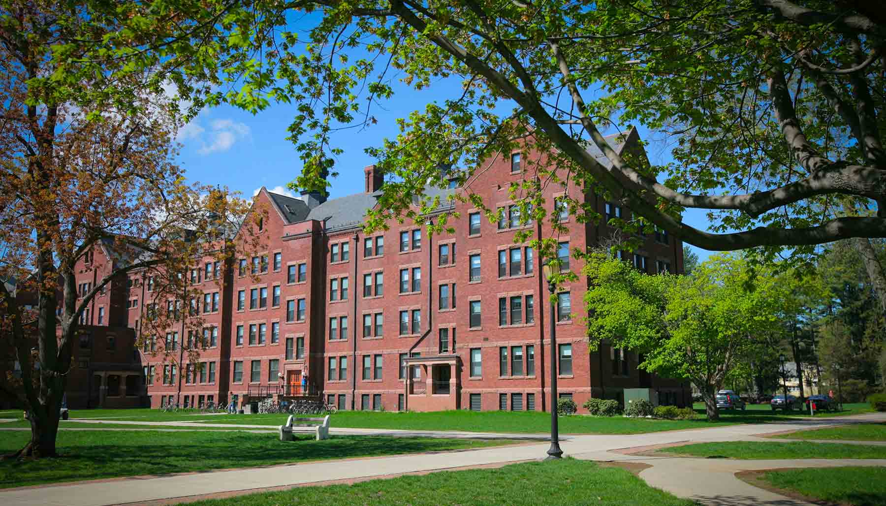 A photo from the center of the residential quad lawn facing a residence house