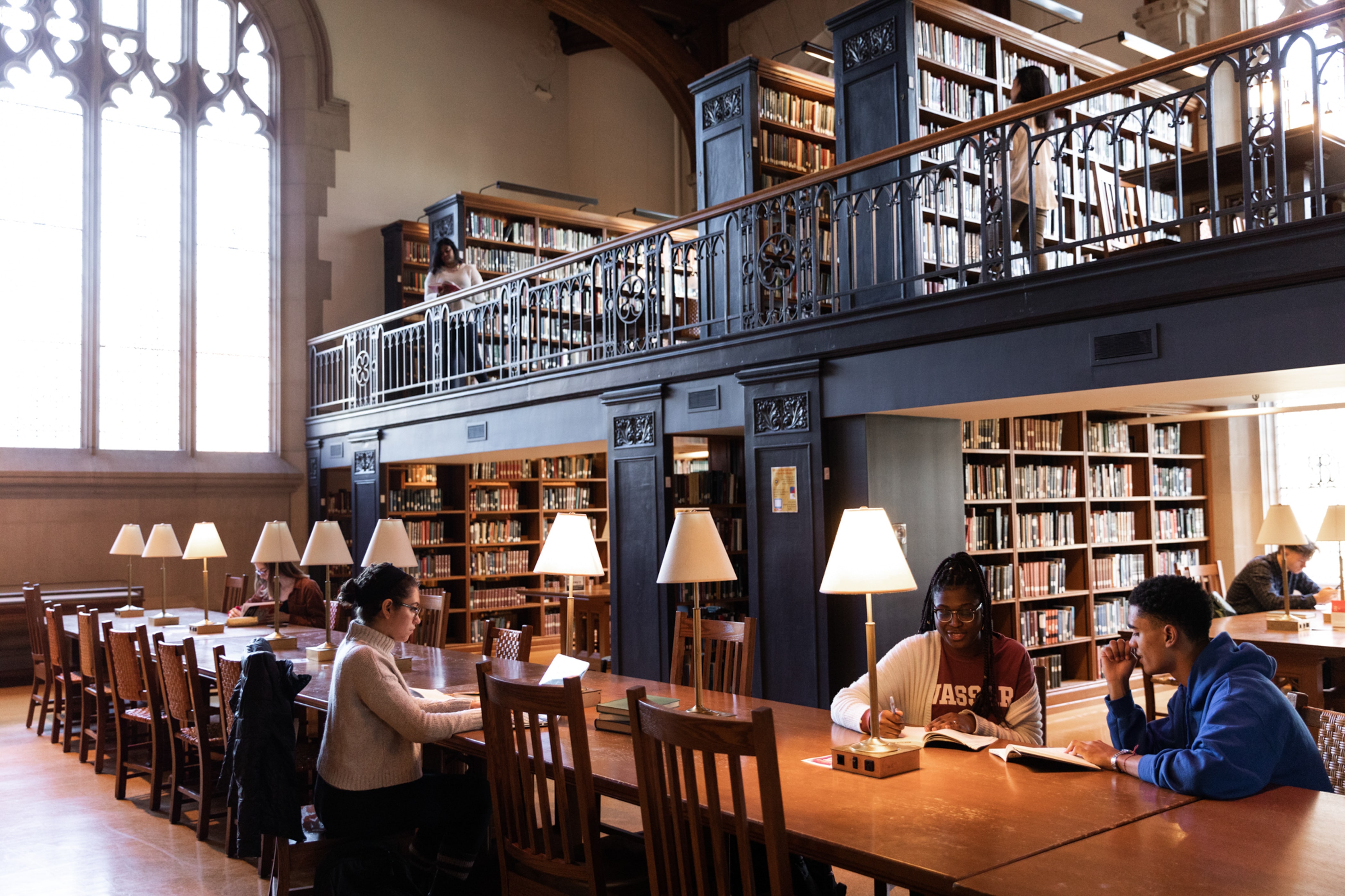 Students sitting at a student table in the libary