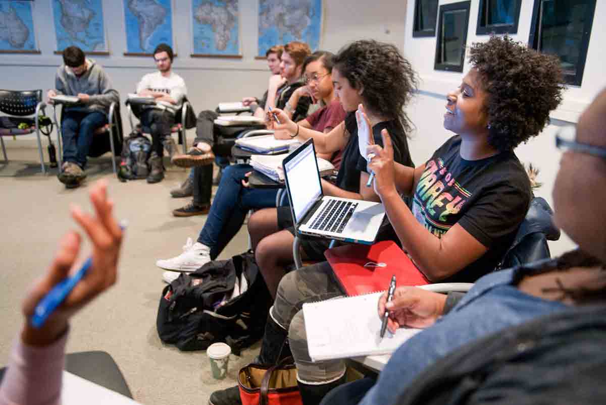 Student speaking in class while others listen.