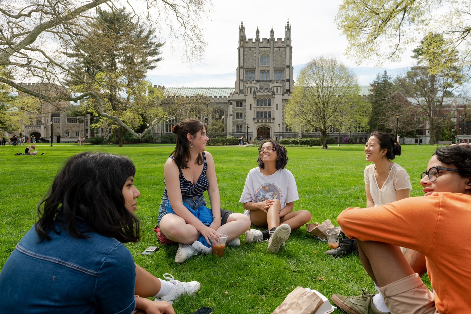 Circle of students in conversation seated on Vassar campus lawn