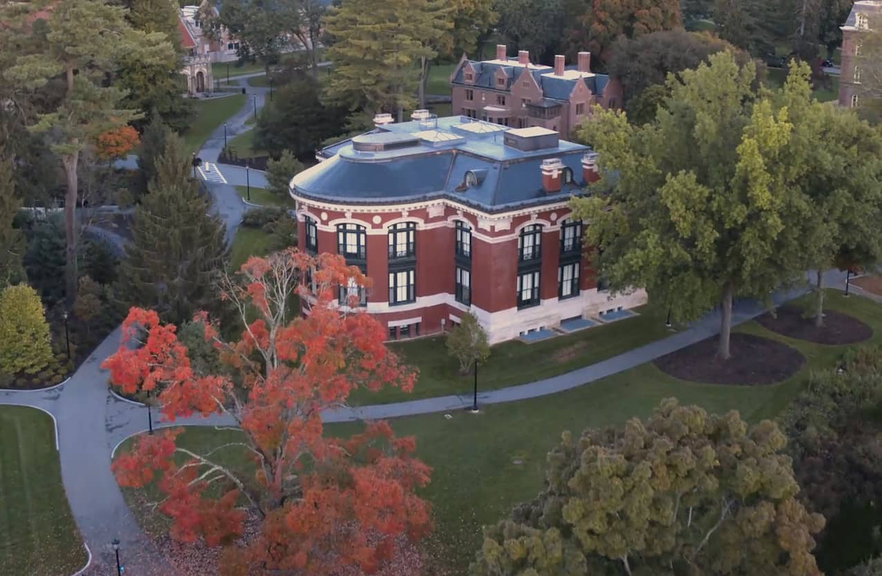 Aerial view of a brick campus building, the New England Building