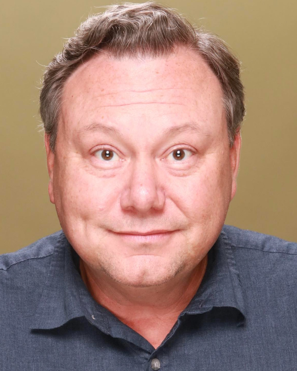 Eddie Gamarra ’94, a person with short brown hair smiling in a close-up portrait.