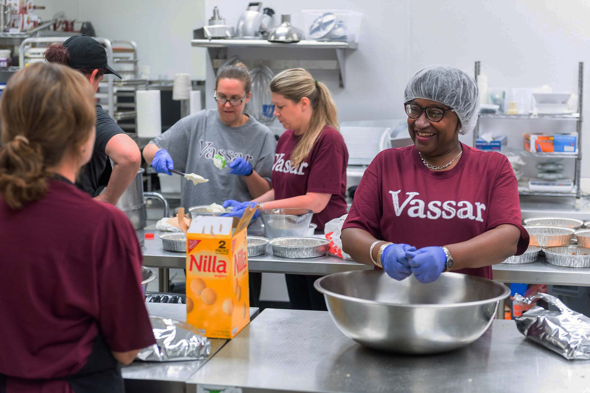 A group of Vassar volunteers food prepping in the Sparrow’s Nest kitchen for families impacted by cancer.