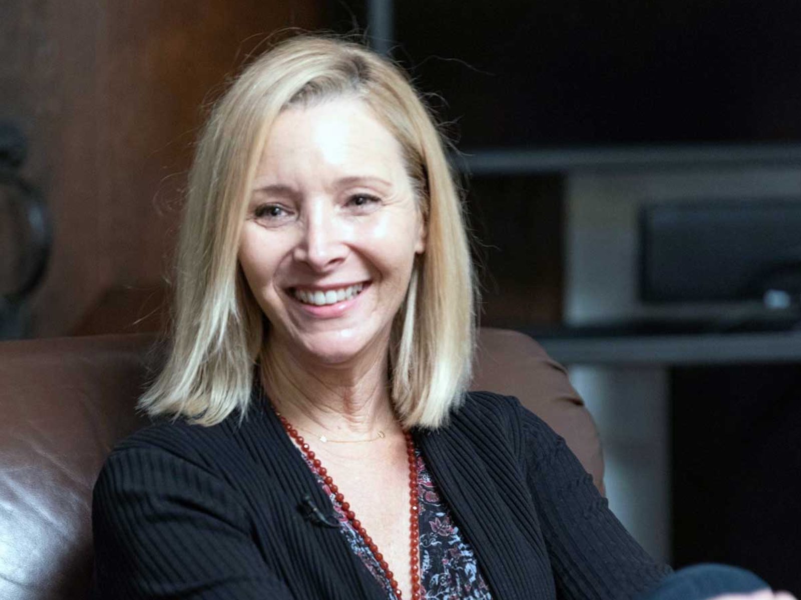 Headshot of Lisa Kudrow, a person with long blond hair and dark clothing.