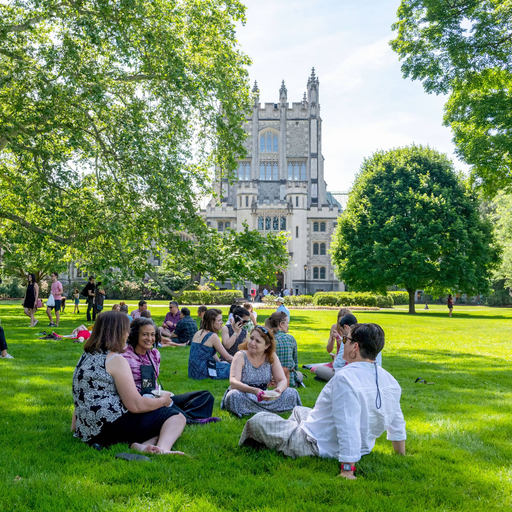 People seated on the lawn in front of Thompson Library on Vassar campus
