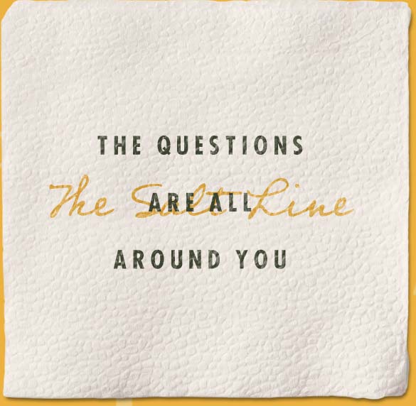 A napkin with "The questions are all around you" on it