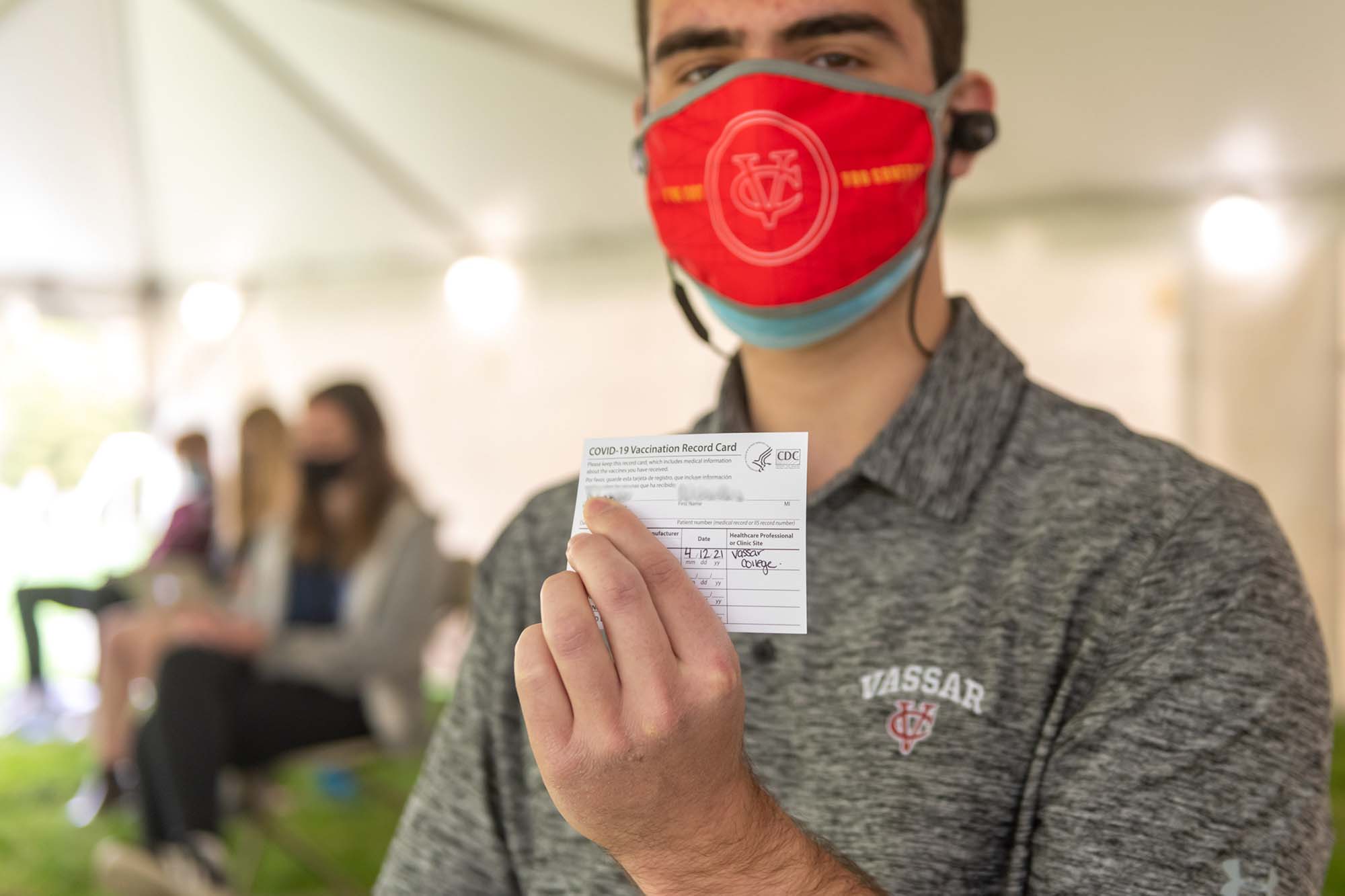 Person holding vaccine card