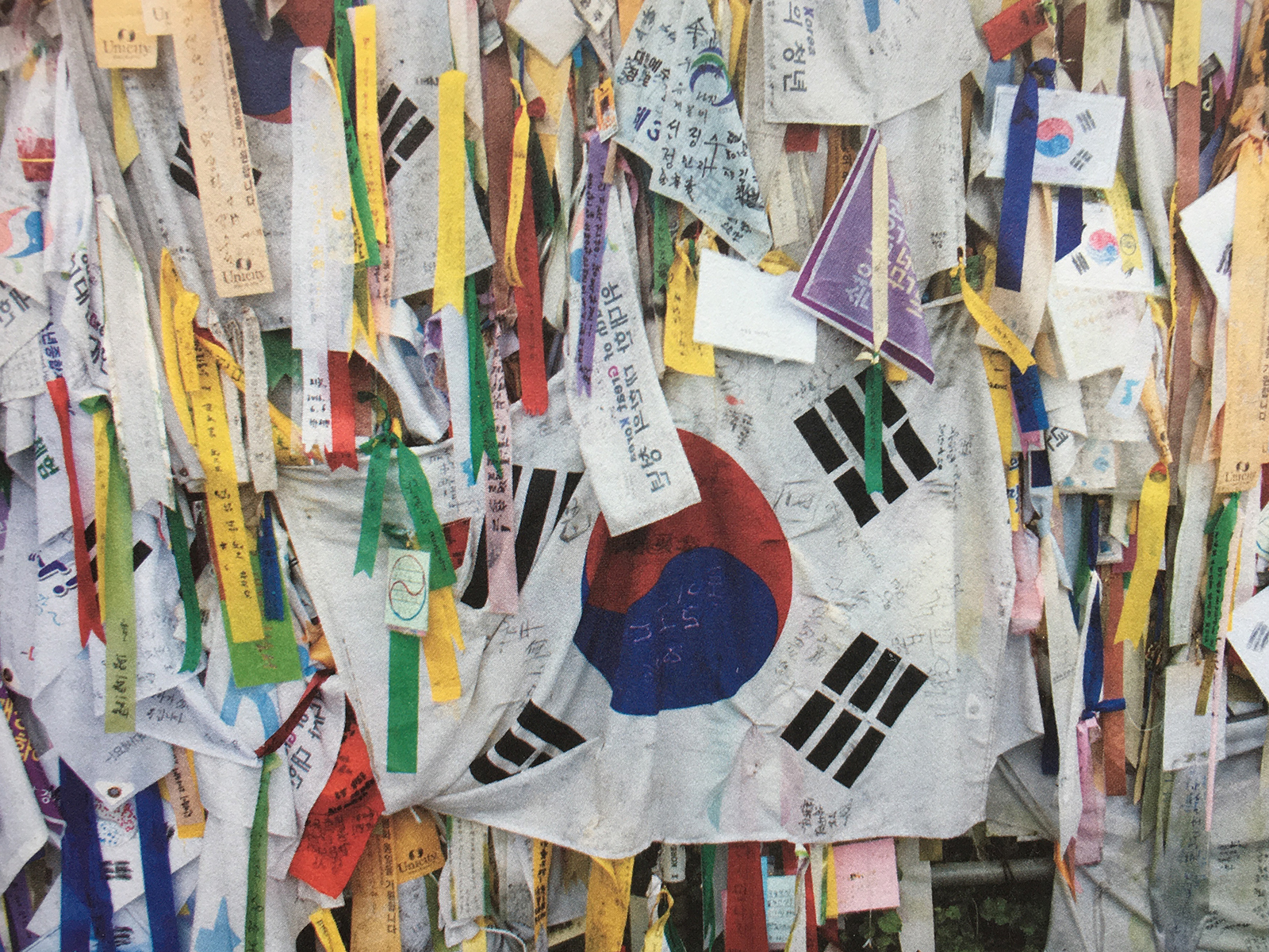 Colorful ribbons hang on a fence in South Korea near the DMZ