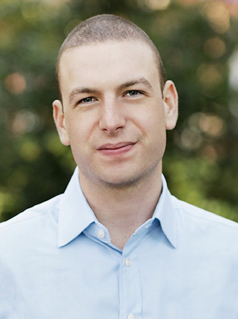 a man in a blue shirt. Caption generated by GenAlt.