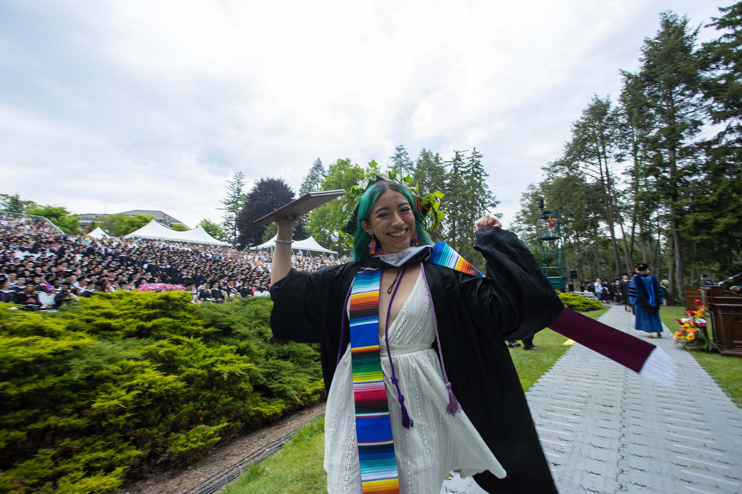 A student is ecstatic upon receiving her diploma.