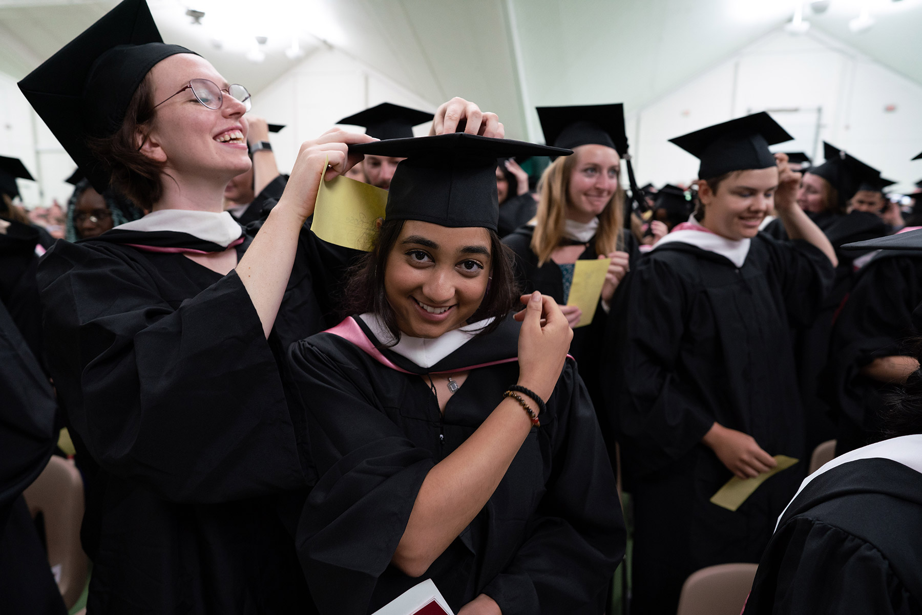 Some needed help fulfilling the tradition of moving their tassels from left to right.