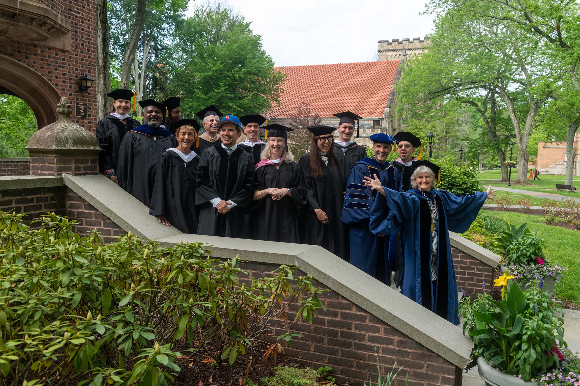 Members of the Board of Trustees pose with Vassar’s 2022 Commencement speaker, John Leguizamo.