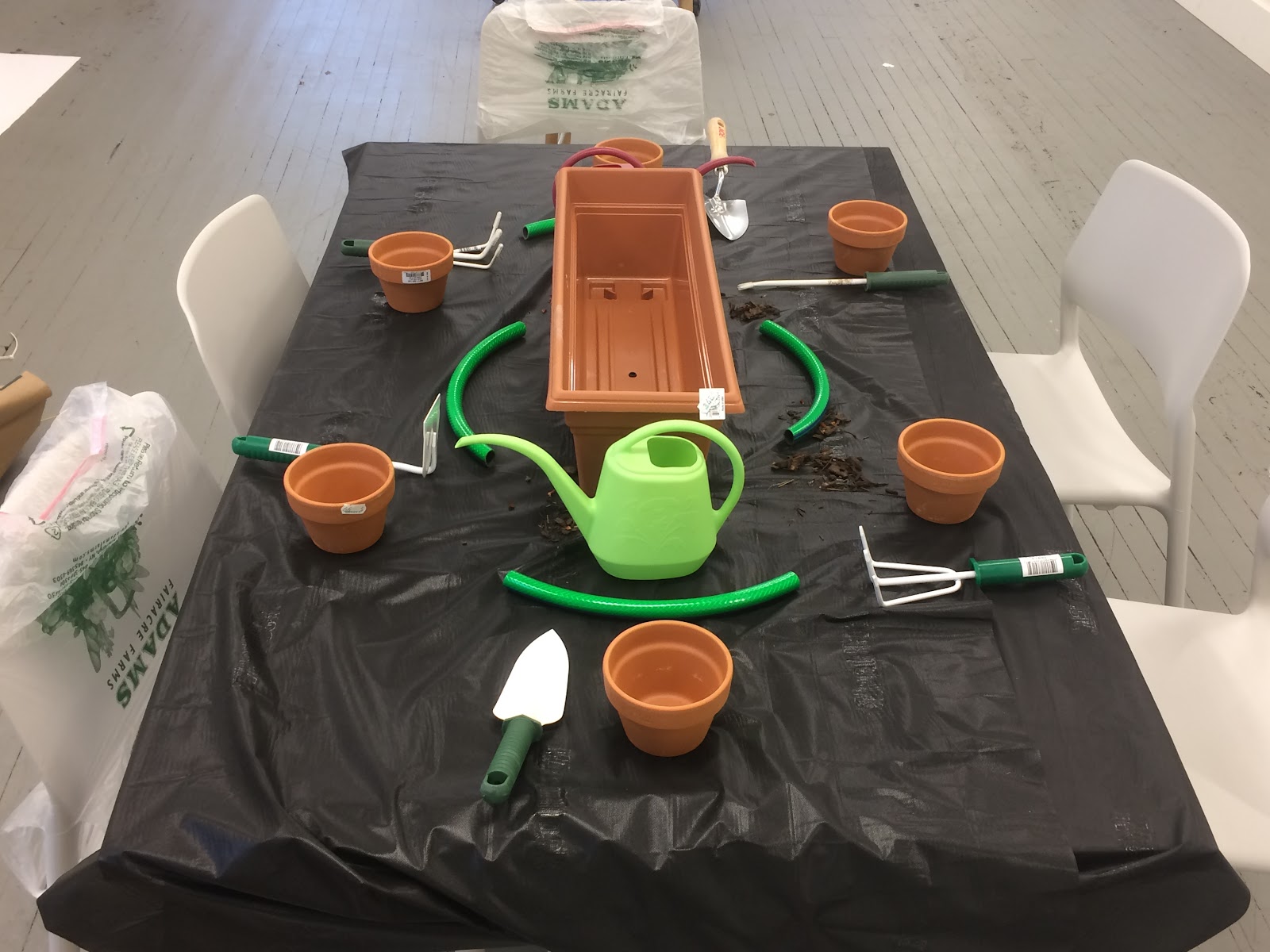 Robert Appleby arranged a table with a meal to be eaten only with gardening tools and flower pots.