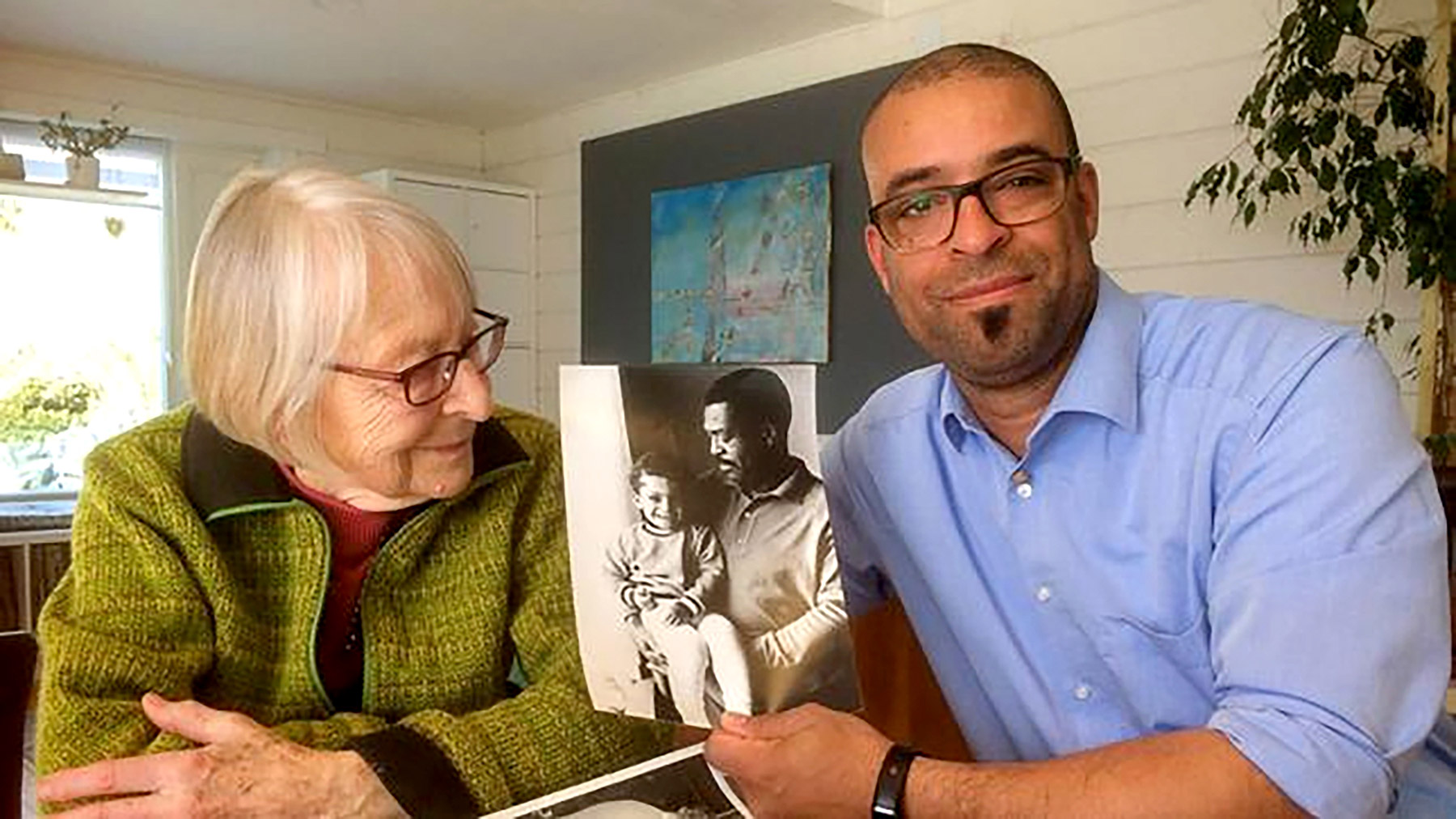 Rosmarie Hawner and her son Raymond Germany with a photo of his father, former G.I. Samuel Germany