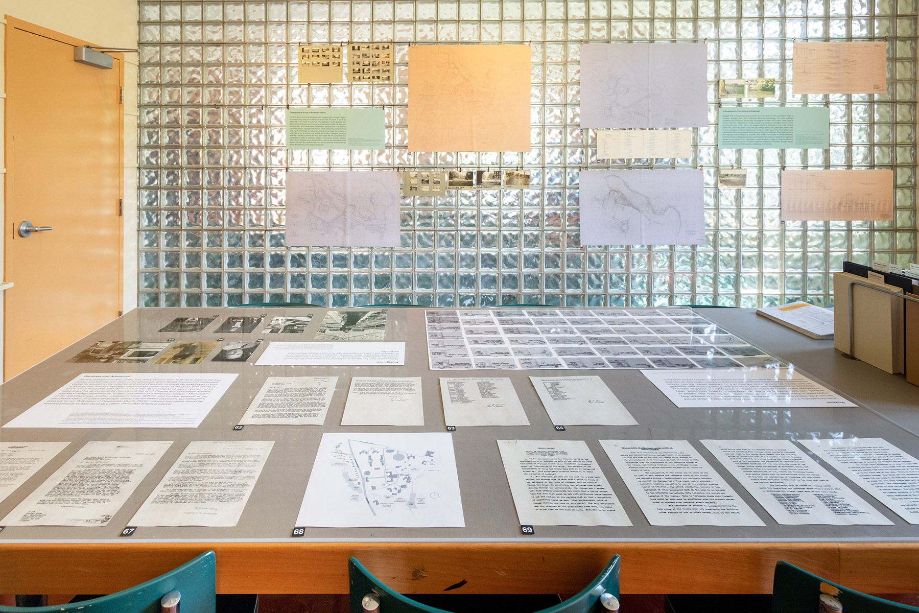 The table vitrine presents Arboretum planting plans and correspondence, and documents showing the organizational practices that the Olmsted firm established for the emerging field of landscape architecture.