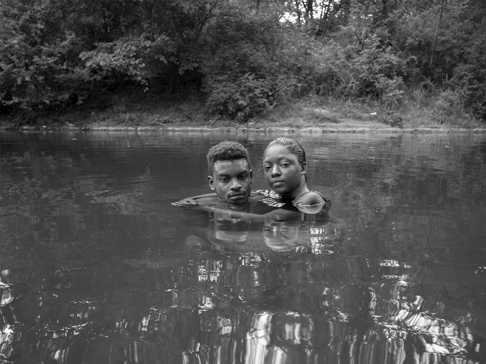 Image of two people in a stream of water
