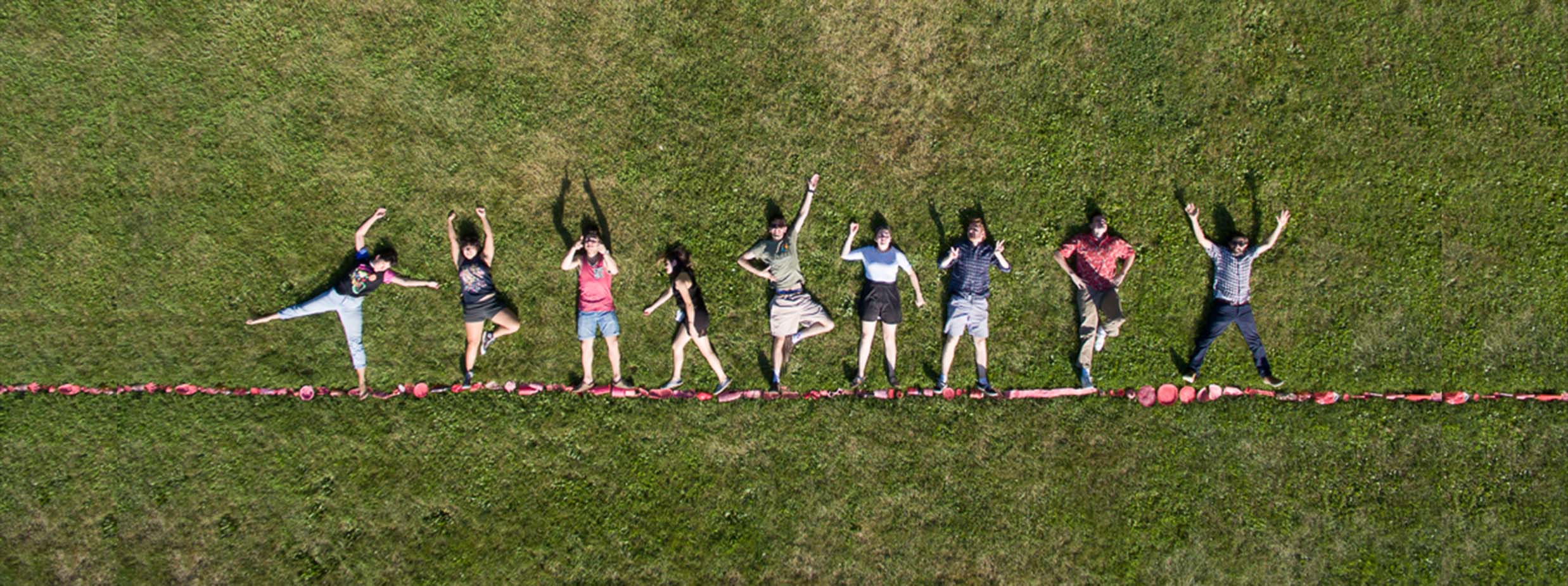 Drone photo with students posing on grass.