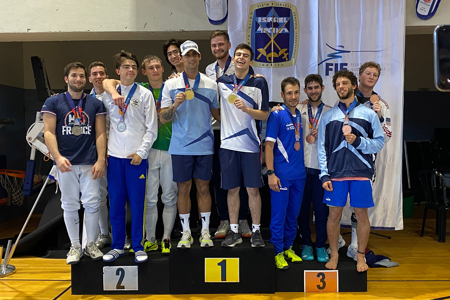 Eli Weise ’25 (third from right) celebrates on the podium with his teammates