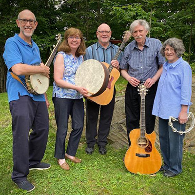 The five musicians who make up the band Storm King Skyline posing outside with their instruments.