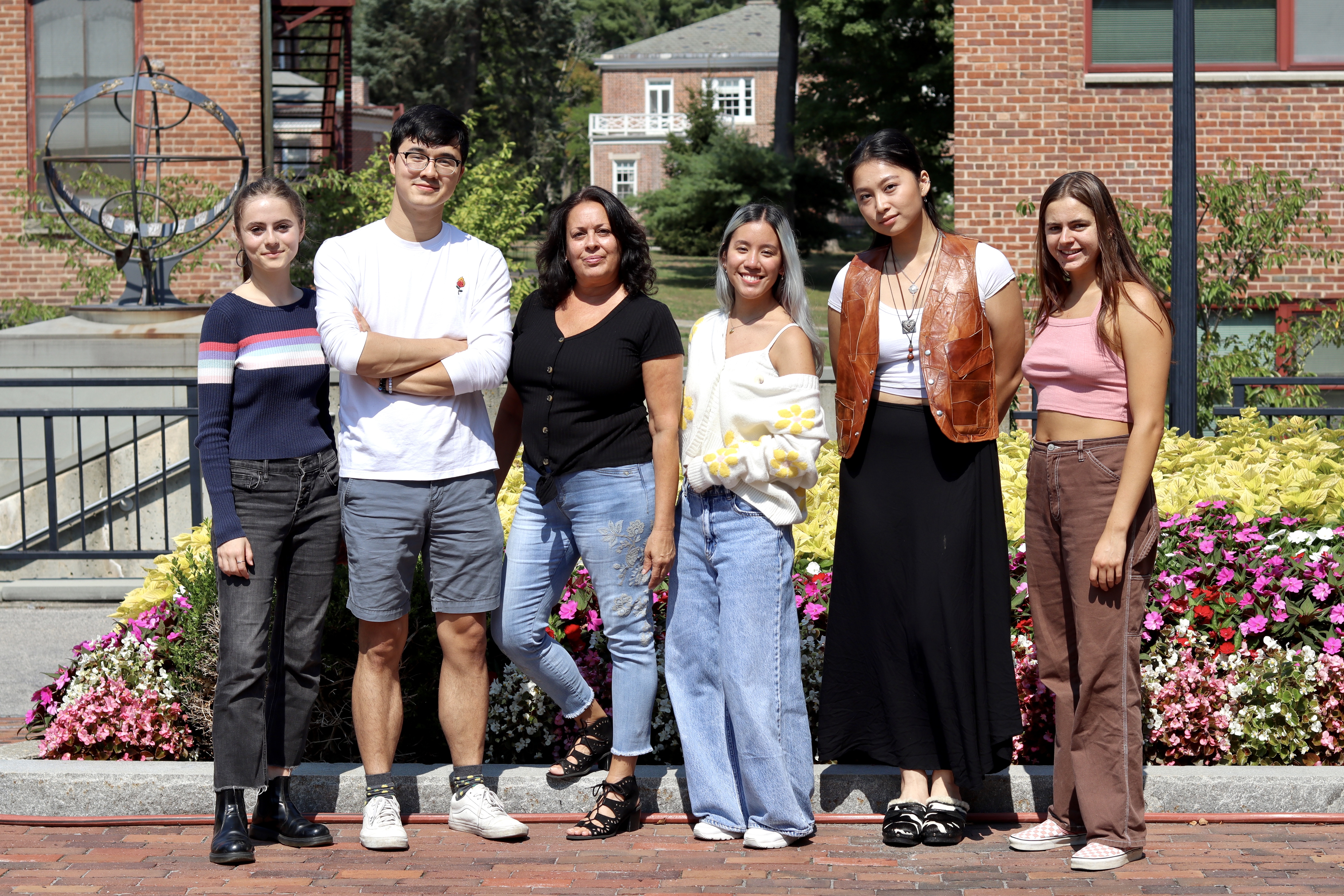 (left to right: Sophia Fredericks '26, Tim Nguyen '23, Joan Gerardi, Ana Leon Urrutia '26, Vi To '23, Alejandra Robins '24) - Students outside standing for picture in front of flowers