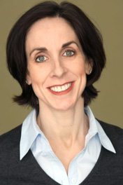 Head and shoulders photo of Harriet Clark wearing a white collared shirt and gray sweater.