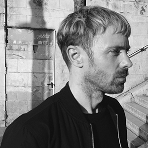 A black-and-white headshot of Nick Rees-Roberts in profile.