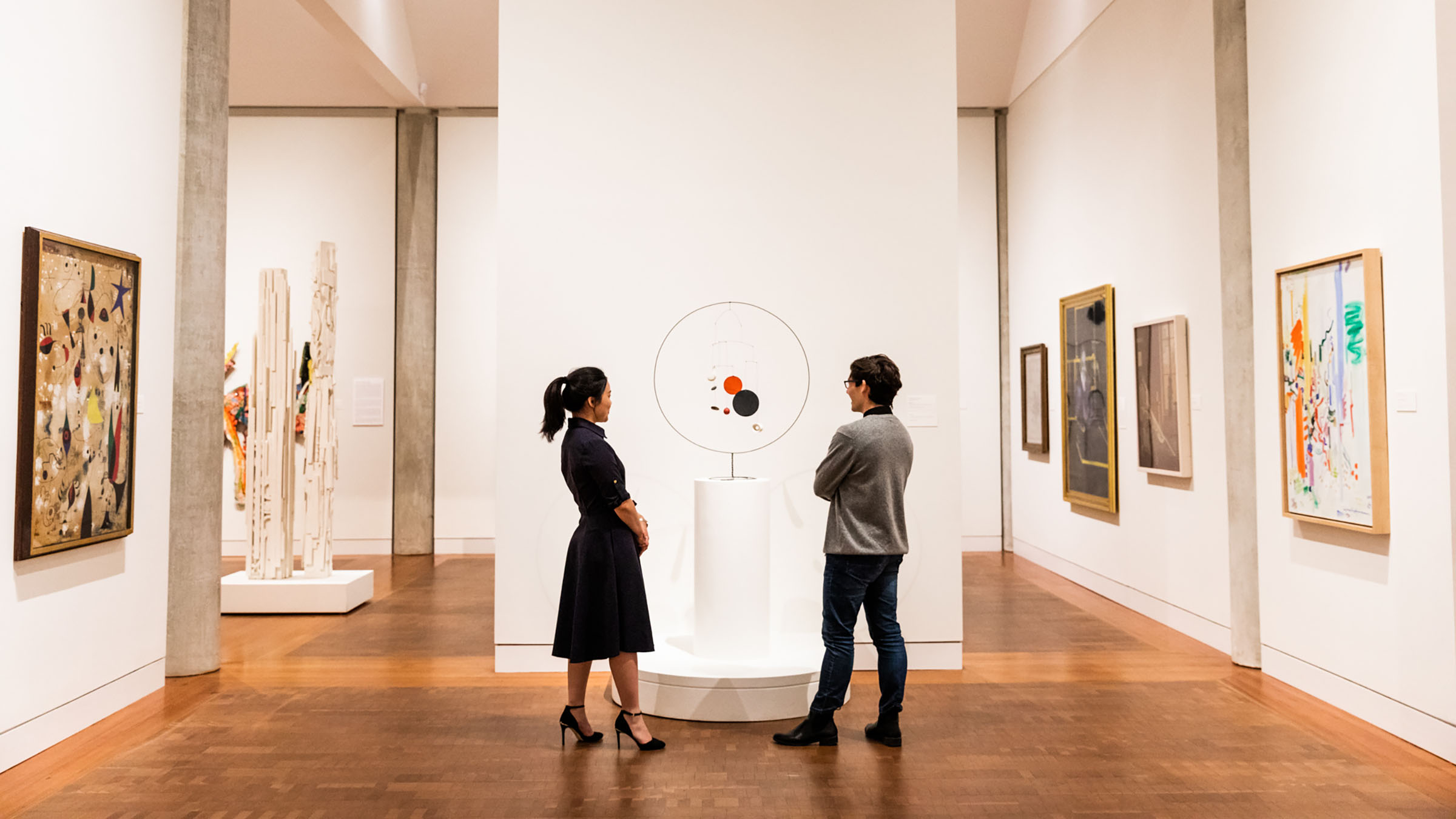 Two people looking at art in The Loeb