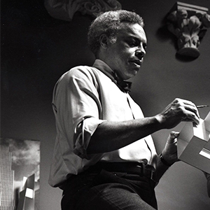 Professor Jeh Vincent Johnson holds an architectural model.