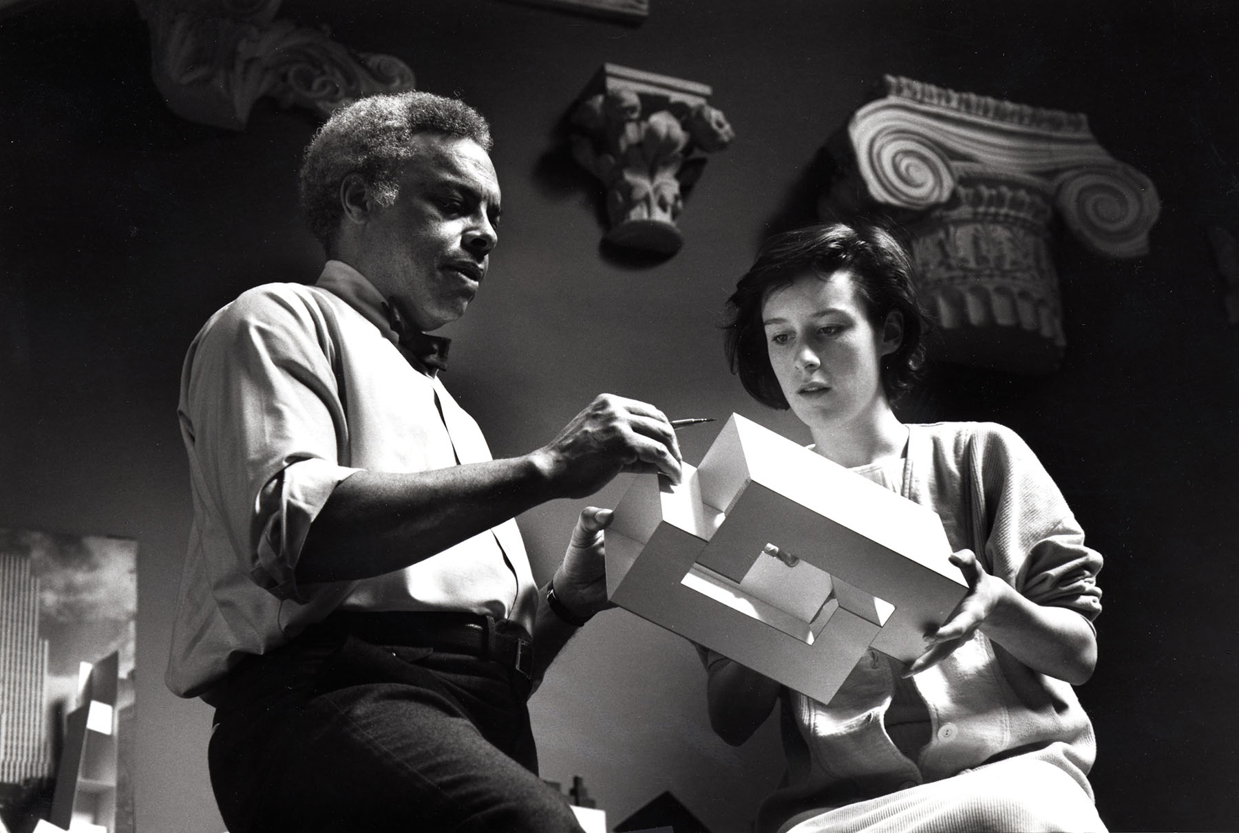 Architect  Jeh Vincent Johnson and a student holding a model