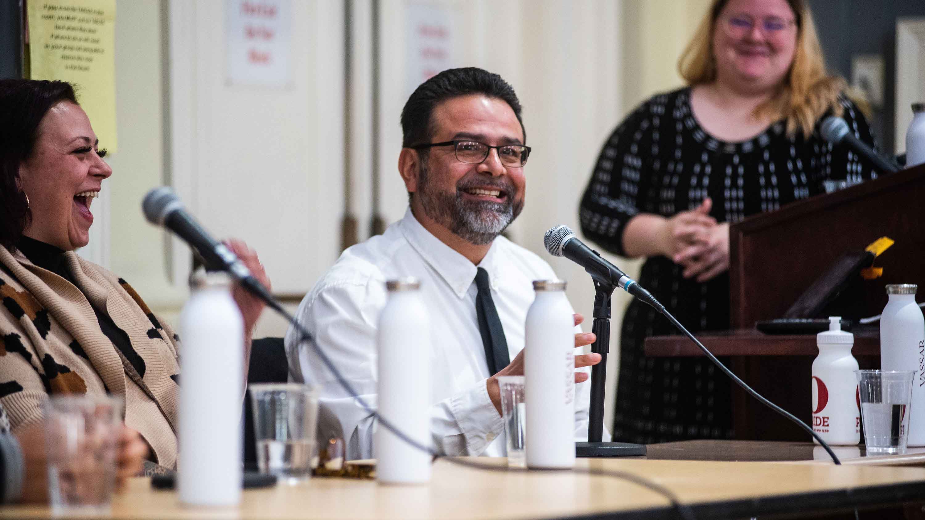 Nicole Leadenham ’18, Jaime Del Razo and Brittany Andrade laughing and smiling during panel discussion.