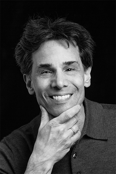 Headshot of Professor Mark Cladis smiling at the camera and resting his chin on his hand.