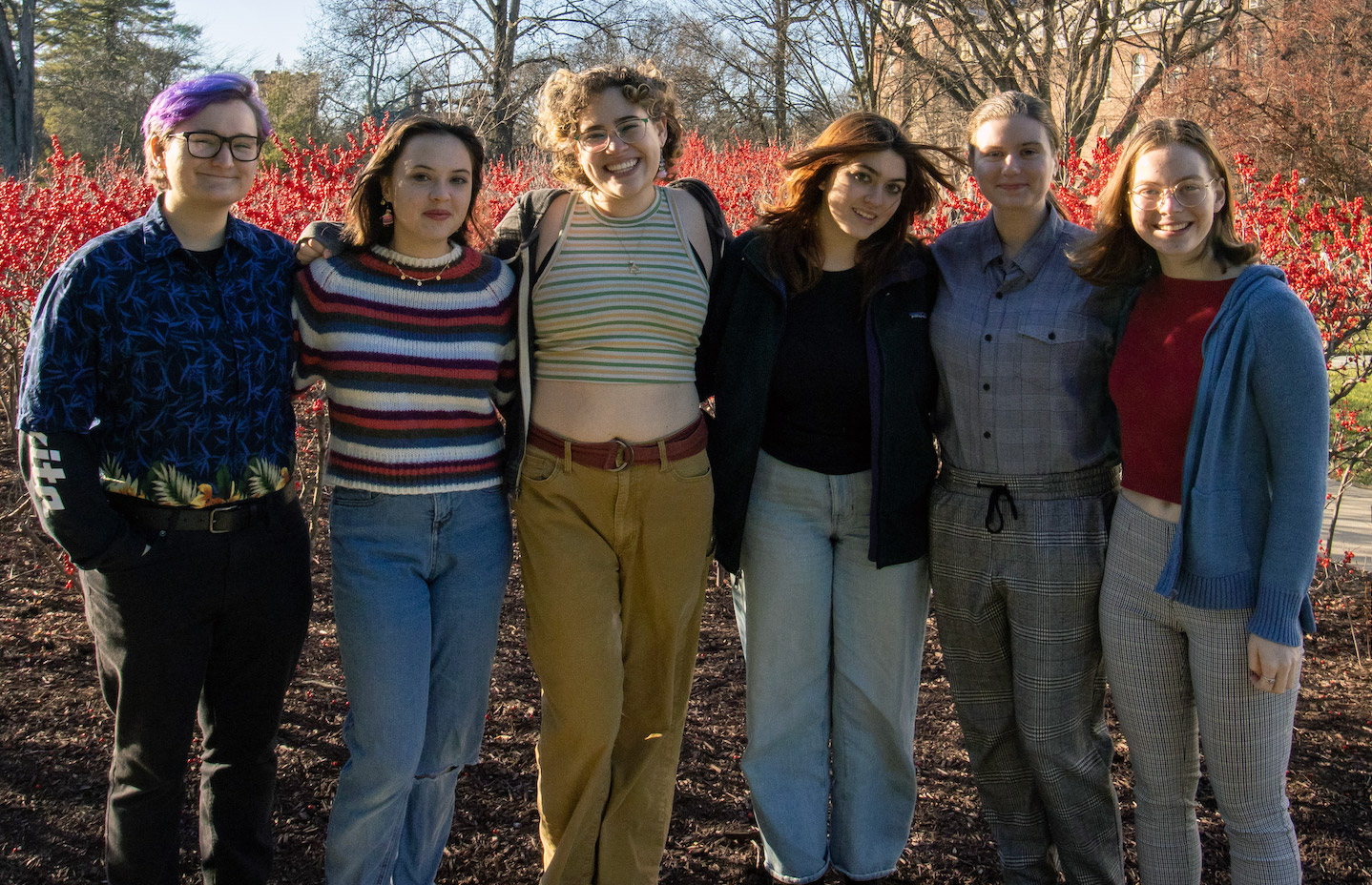 The Drama Majors Committee 2022/2023 - 6 students standing on campus in front of flowering bushes.