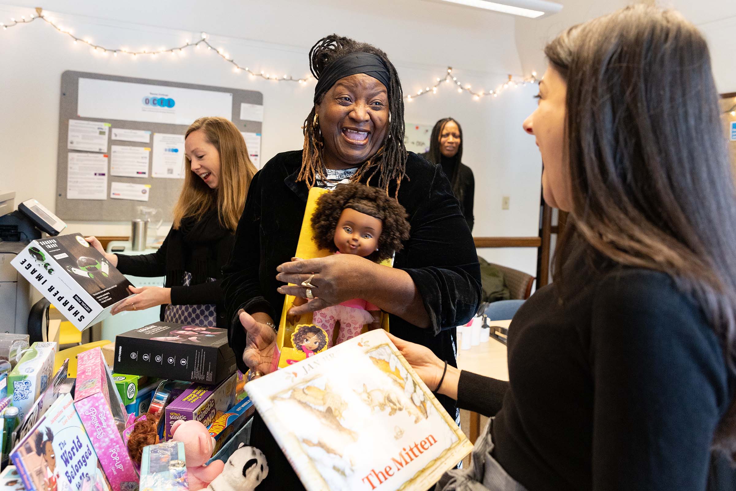 People holding toys at a toy drive