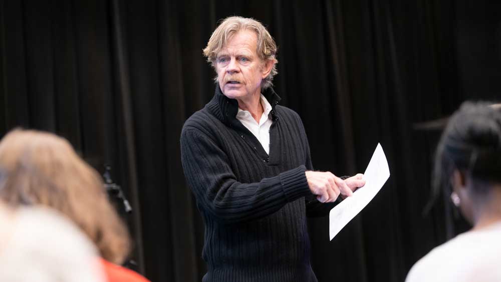 Willam H. Macy is directing a Masterclass and pointing to a script he is holding in his hand