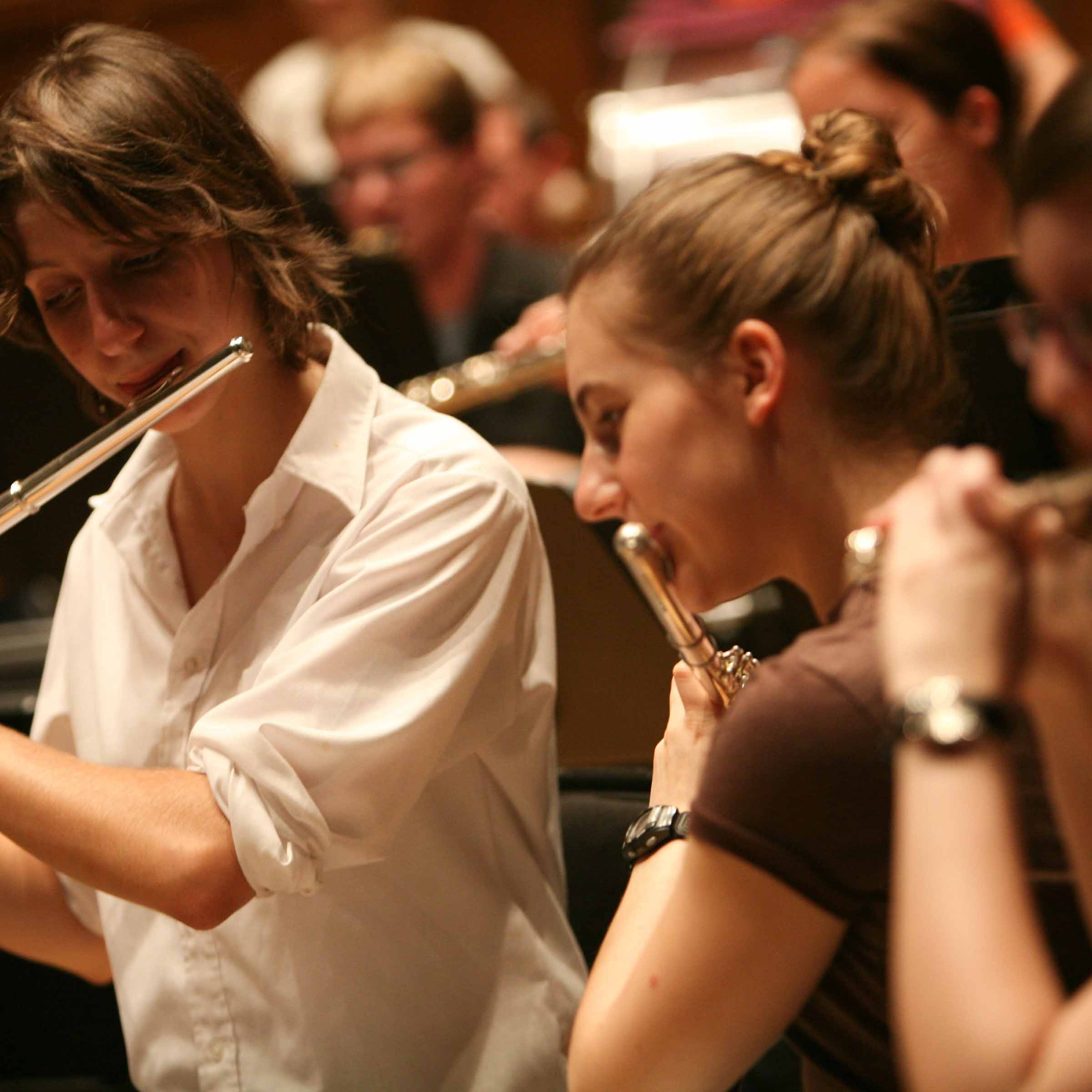 Square image of musicians playing wind instruments