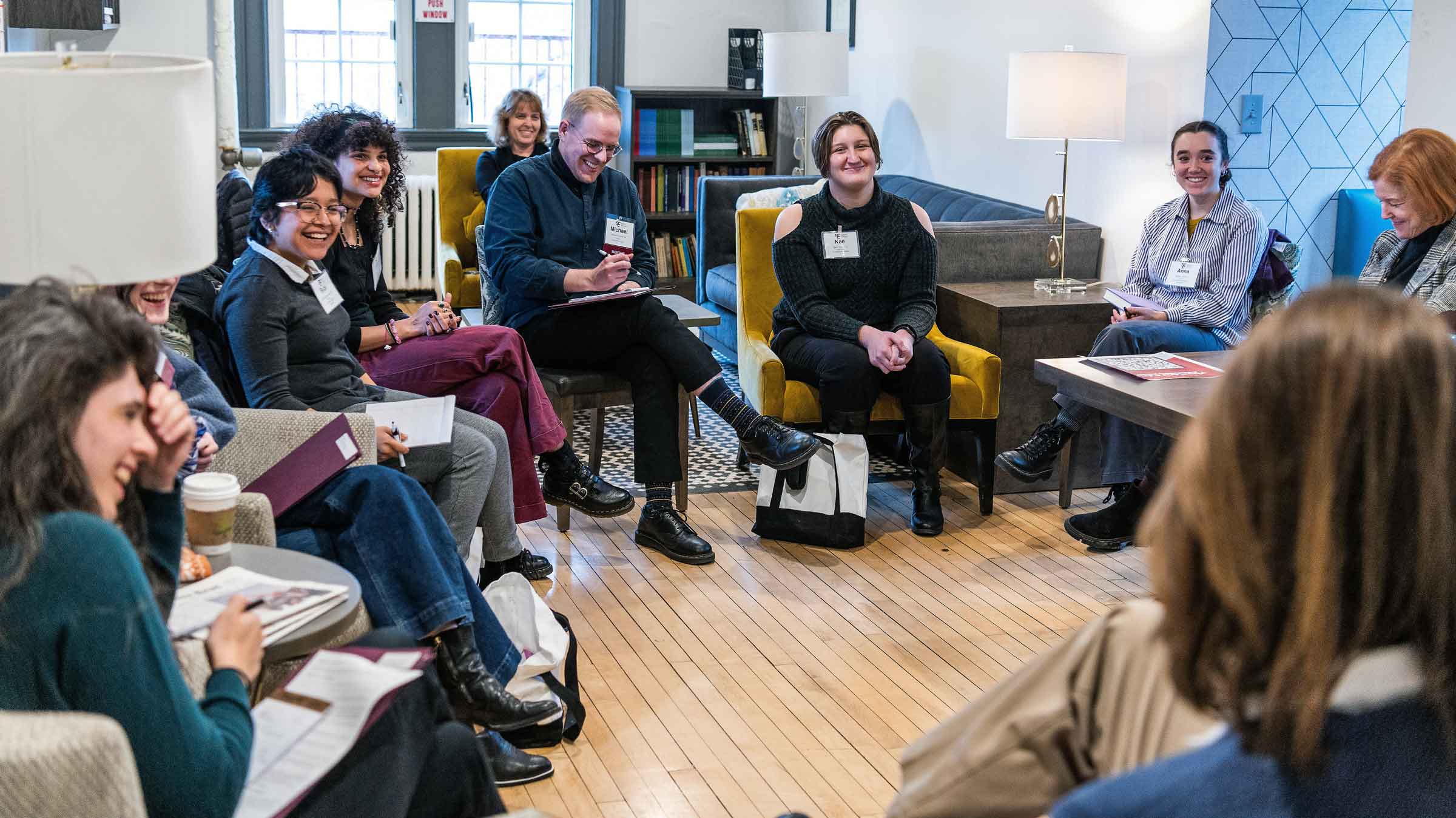 Group of people seated in a circle smiling and laughing