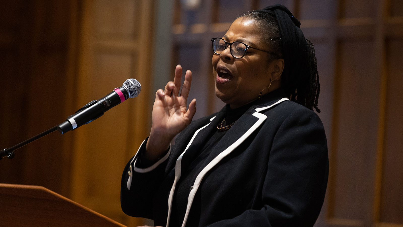 Jen Brown sings at the podium during the MLK Day breakfast in the Villard Room