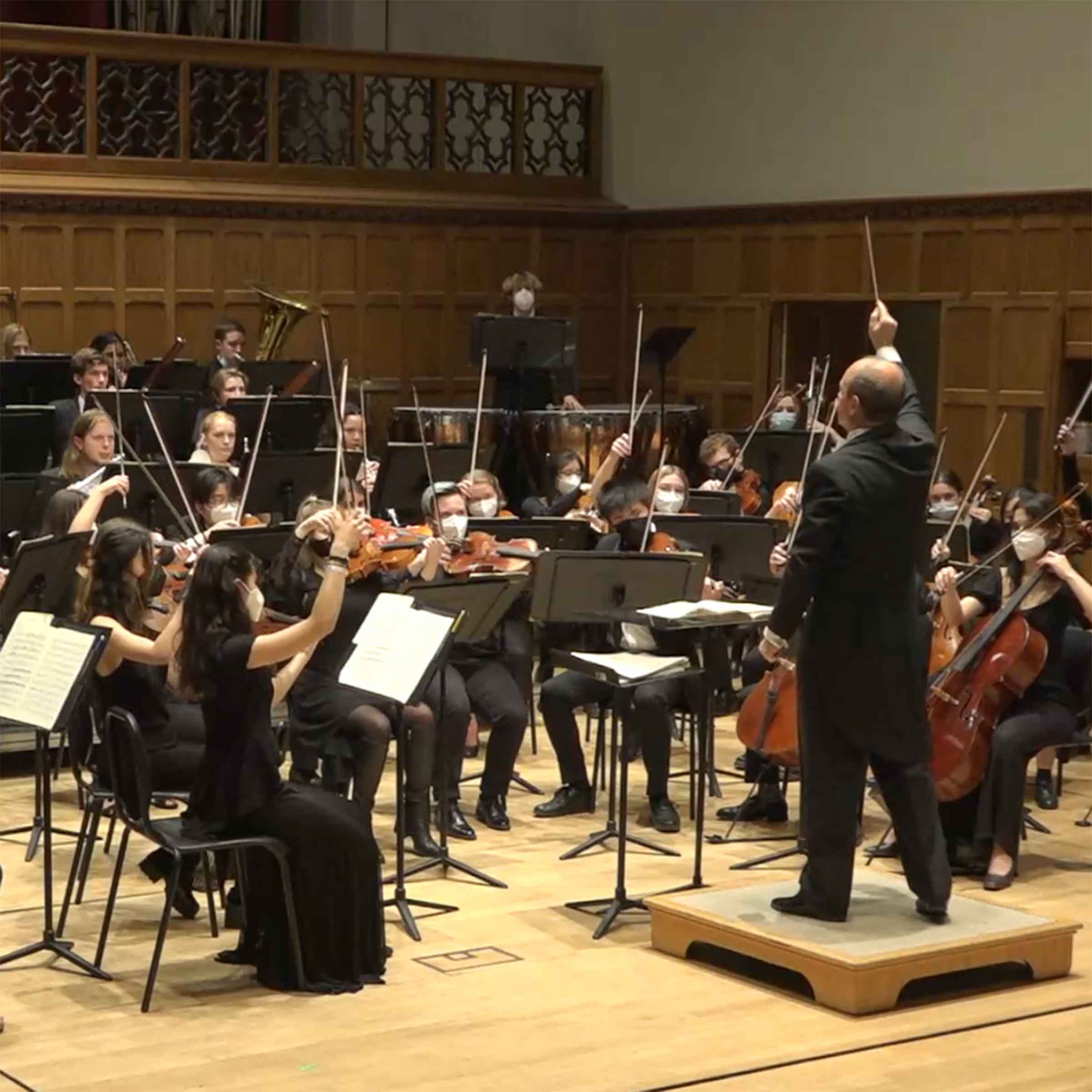 Image of a conductor and orchestra