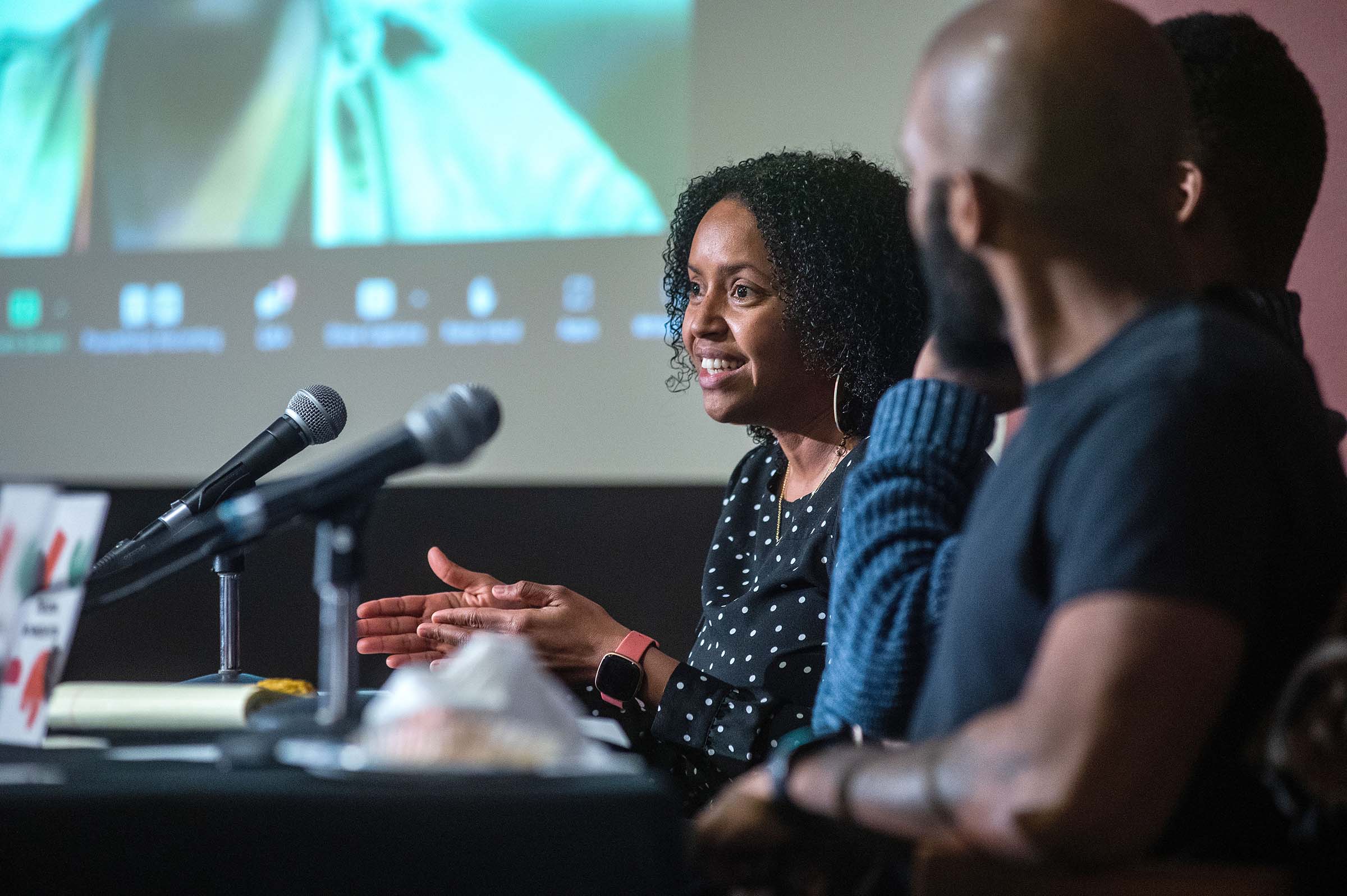 Assistant Professor of Chemistry Krystle McLaughlin sitting at a table in front of microphones