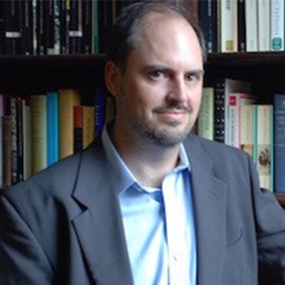 Nicholas Dames standing in front of a bookcase