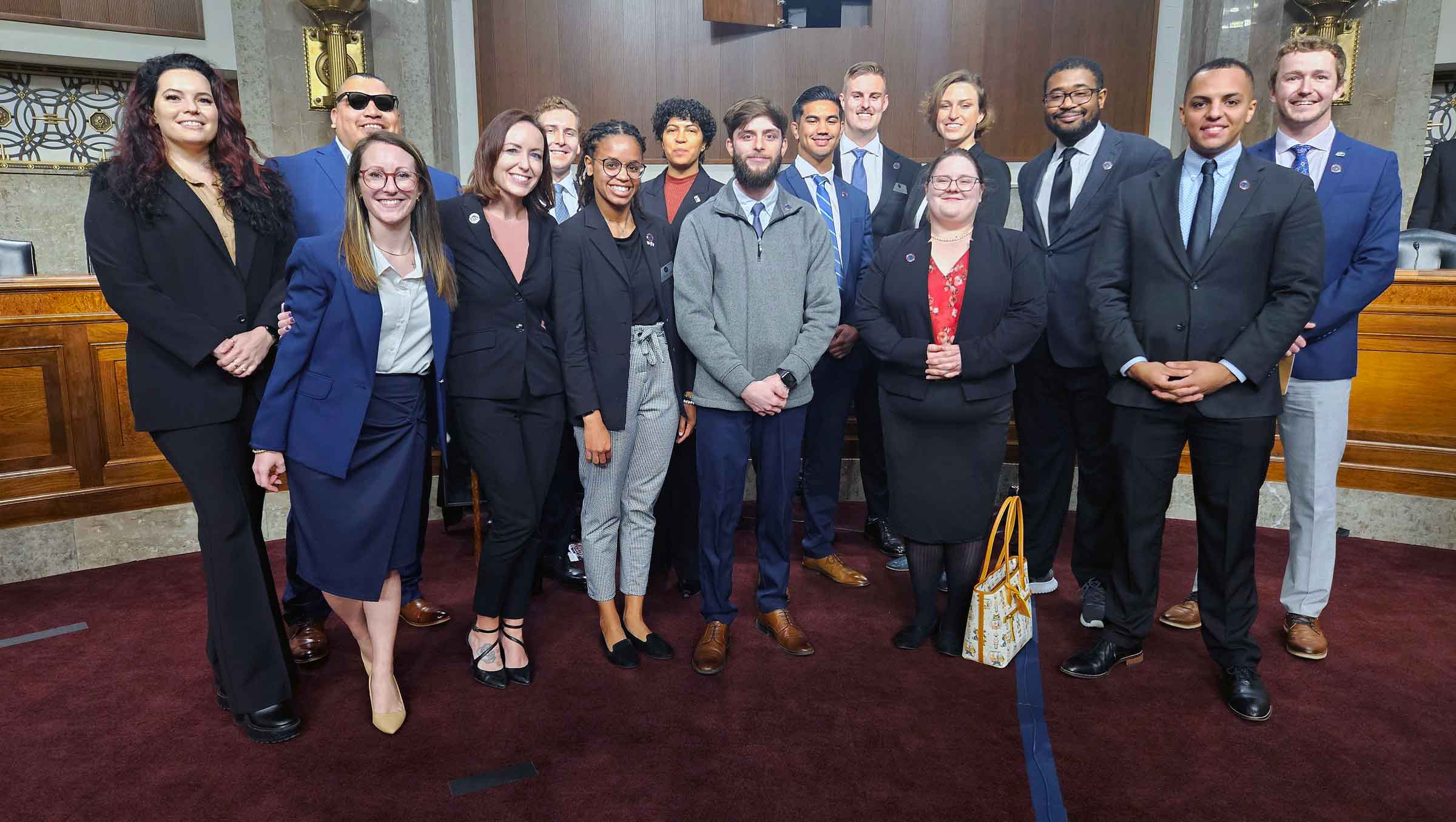 Large group of people dressed formally posing for a photo