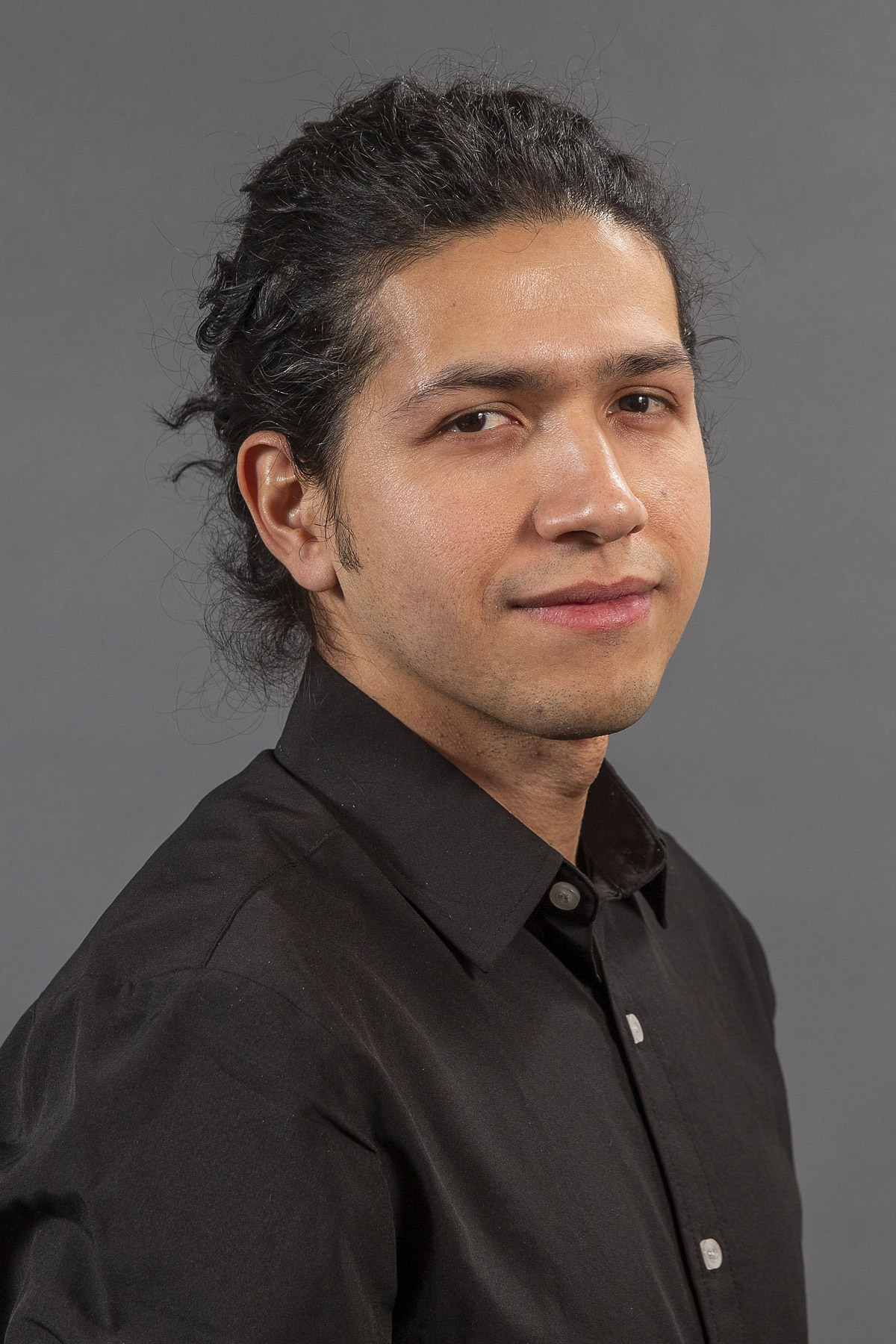 Man in black dress shirt -  Pictured: Carlos Alvarado