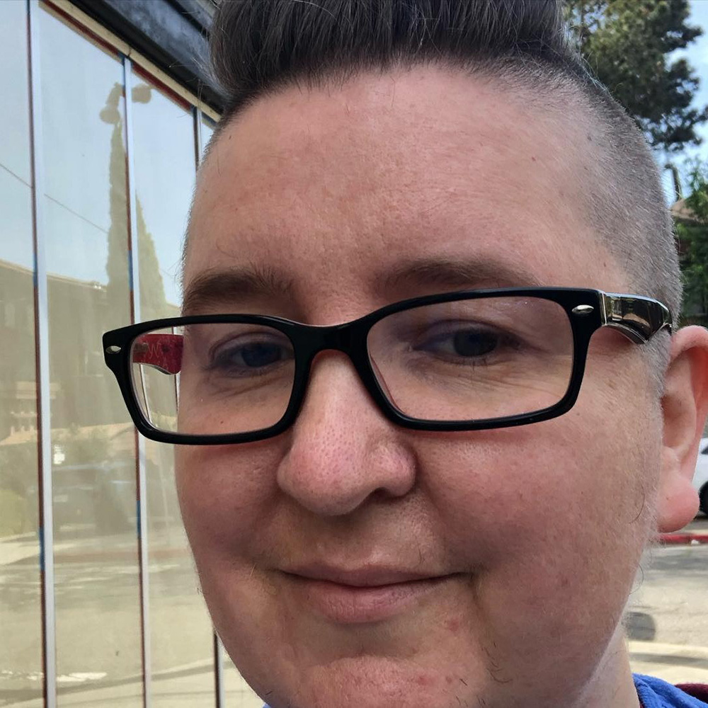 Lyo Demi Green wearing glasses.